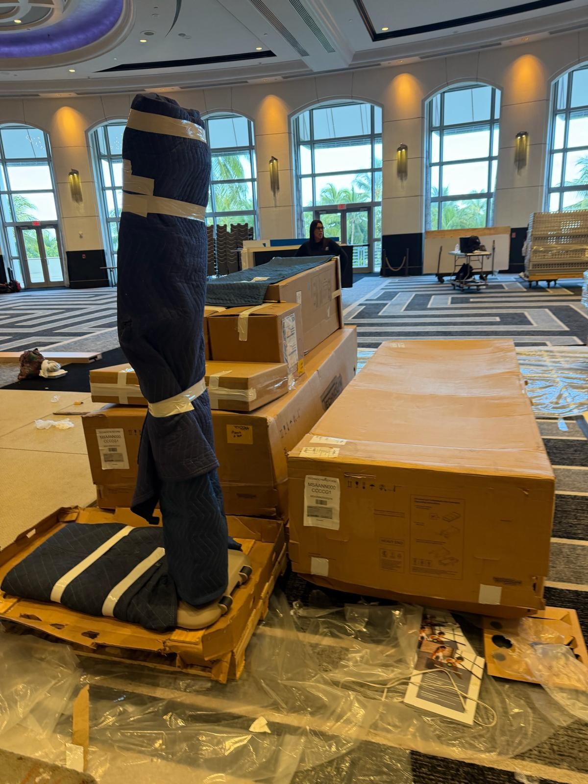 Freight pallets and equipment wrapped for trade show delivery in hotel ballroom