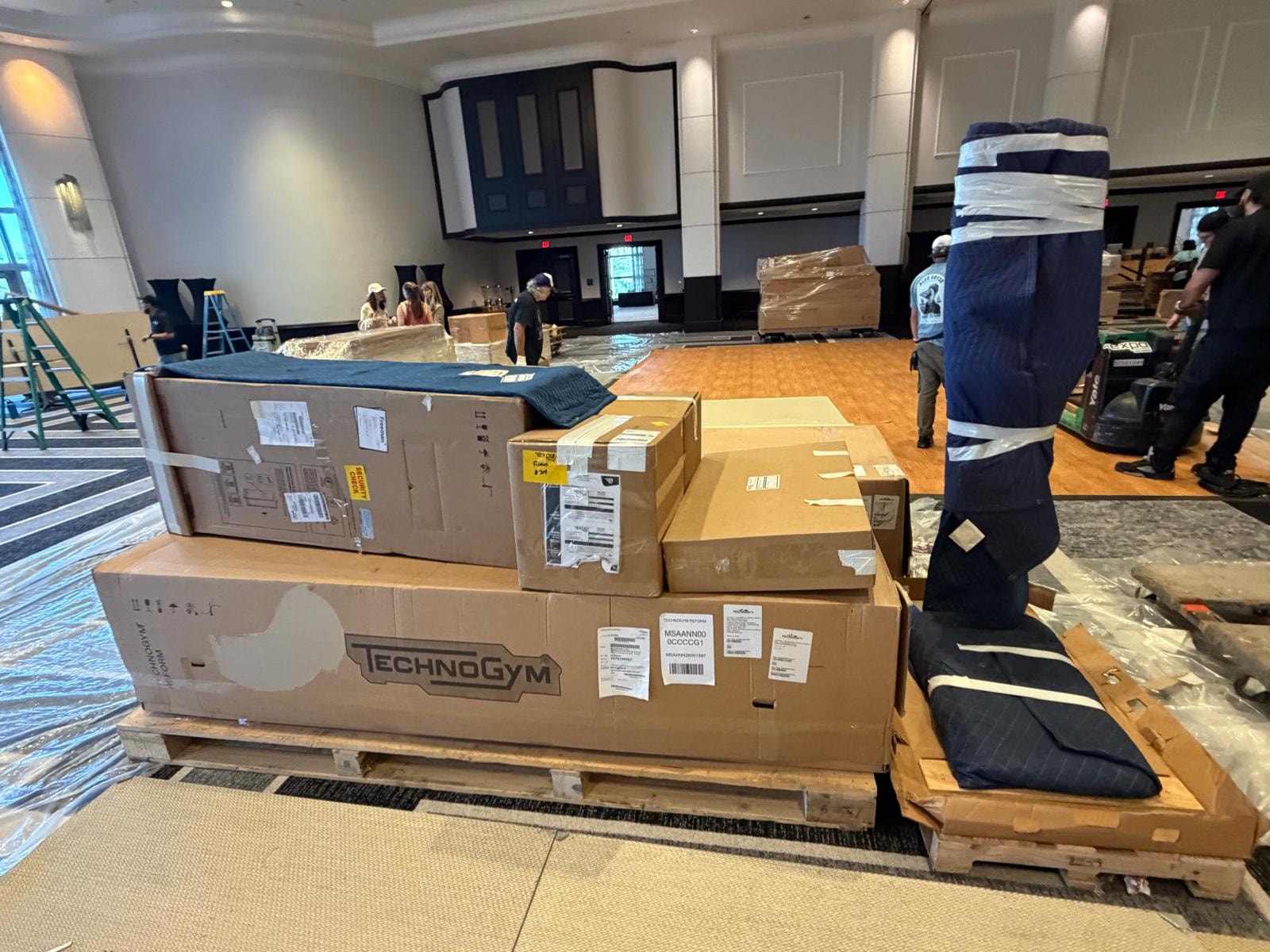 TechnoGym boxes and equipment pallets staged in hotel ballroom