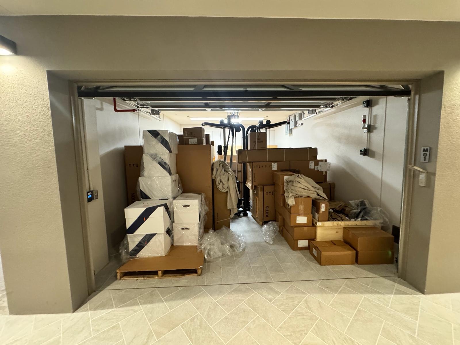 Storage room packed with boxed fitness equipment ready for installation