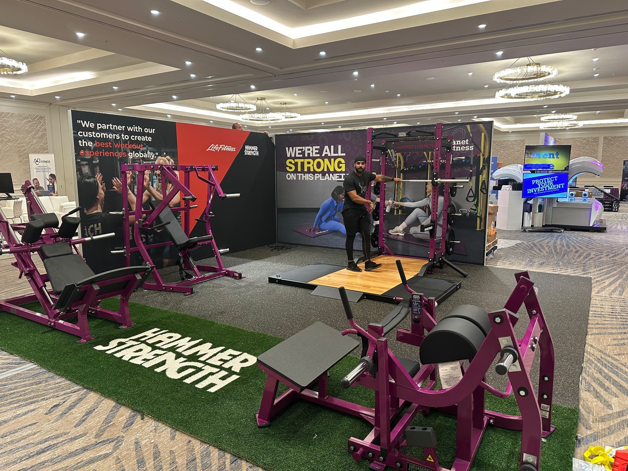 Planet Fitness trade show booth with purple Hammer Strength equipment